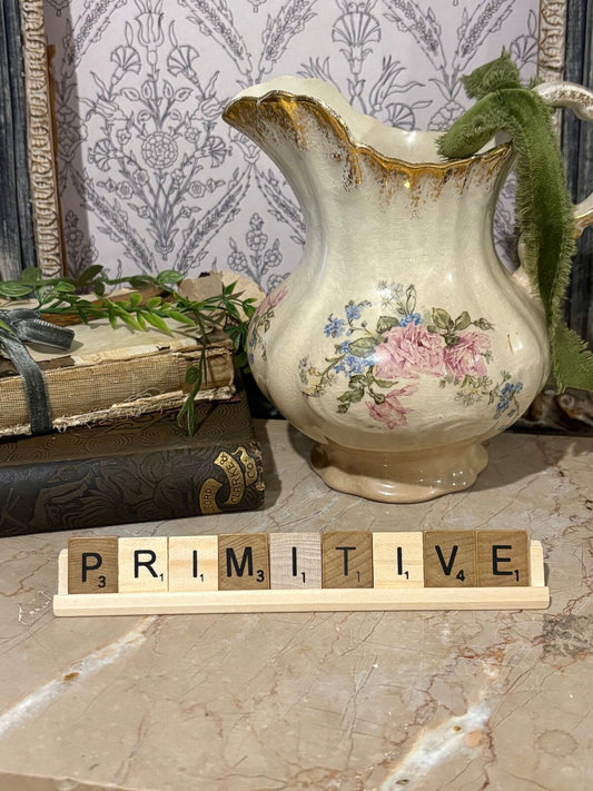 Scrabble letter tiles & stand “primitive”